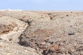 Apocalyptic landscape like a planet Mars surface. Solidified red-brown black Earth surface. Barren, cracked and scorched land. Royalty Free Stock Photo