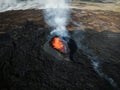 Apocalyptic surroundings of an erupted volcano, lava and smoke spreading, aerial