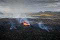 Apocalyptic surroundings of an erupted volcano, lava and smoke spreading, aerial