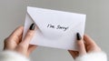 Apology letter with i\'m sorry message on white envelope held by female hands Royalty Free Stock Photo