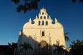 Apostle Church `Parroquia de Santiago Apostol` framed by tropical plants, old Roman Catholic church with bell towers in Merida,
