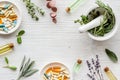 Apothecary of natural wellness and self-care. Herbs and medicine on white wooden background top view frame copy space