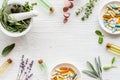 Apothecary of natural wellness and self-care. Herbs and medicine on white wooden background top view frame copy space Royalty Free Stock Photo