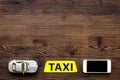 App for order a taxi online with car toy and mobile on wooden background top view space for text Royalty Free Stock Photo