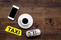 App for order a taxi online with car toy and mobile on wooden background top view space for text Royalty Free Stock Photo