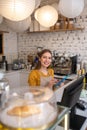 Cheerful cafe employee taking orders online via tablet Royalty Free Stock Photo
