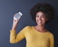 This is a app you dont wanna miss out on. Studio shot of a young woman holding up her phone against a grey background.