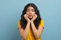 Appalled young indian woman touching her face Royalty Free Stock Photo