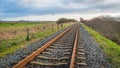 Apparently endless rusty rail tracks on concrete sleepers Royalty Free Stock Photo