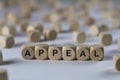 Appeal - cube with letters, sign with wooden cubes