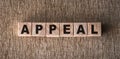 APPEAL word written on wooden blocks on a brown background