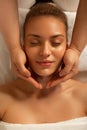 Appealing lady lying with closed eyes during relaxing massage