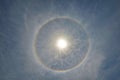 Full circle rainbow around Sun at noon, rays catch the thin vapour formed of ice crystals Royalty Free Stock Photo