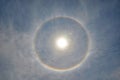 Full circle rainbow around Sun at noon, rays catch the thin vapour formed of ice crystals Royalty Free Stock Photo