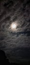 The appearance of a bright moon surrounded by clouds in the sky. Royalty Free Stock Photo