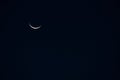 The appearance of the crescent moon hilal in the sky in the fasting month of Ramadan. There is a negative space in this photo