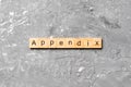 Appendix word written on wood block. appendix text on table, concept Royalty Free Stock Photo