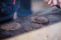 Appetising beef burgers being grilled outdoors on open kitchen at music festival event