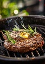 Appetite: Big beef steak, perfectly roasted with rosemary herbs and pepper, sizzling on a cast iron grill pan. Enhanced with Royalty Free Stock Photo