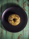 Appetite glazed yellow donut on black plate