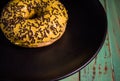 Appetite glazed yellow donut on black plate