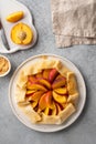 Appetite summer peach galeta on white table with copy space. summer open tart photo for cook book or food blog. Royalty Free Stock Photo