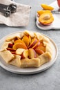 Appetite summer peach galeta on white table with copy space. summer open tart photo for cook book or food blog. Royalty Free Stock Photo