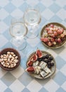 Appetizer, aperitif, tapas - glasses of white wine, red grapes, figs, gorgonzola, pistachios on a light background, top view Royalty Free Stock Photo