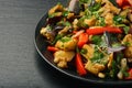 Appetizer - asian salad with eggplants, paprika and garlic on black background.