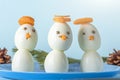 Appetizer from boiled eggs and carrot. Funny snowmans. Kid`s menu for Christmas and New Year