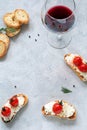 Appetizer bruschetta with cheese and tomatoes and glass of wine