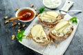 Appetizer bruschetta with pear, honey, walnut and cottage cheese on white board. Royalty Free Stock Photo