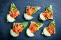 Appetizer canape with chopped vegetables and sesame on stone slate background close up. Royalty Free Stock Photo