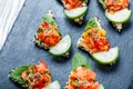 Appetizer canape with chopped vegetables and sesame on stone slate background close up. Royalty Free Stock Photo