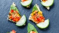 Appetizer canape with chopped vegetables and sesame on stone slate background close up. Royalty Free Stock Photo