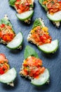 Appetizer canape with chopped vegetables and sesame on stone slate background close up. Royalty Free Stock Photo