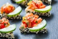 Appetizer canape with chopped vegetables and sesame on stone slate background close up. Royalty Free Stock Photo