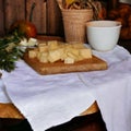 Appetizer with cheese cubes on wooden board- Royalty Free Stock Photo