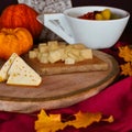 Appetizer with cheese cubes on wooden board- Royalty Free Stock Photo