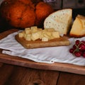 Appetizer with cheese cubes on wooden board- Royalty Free Stock Photo