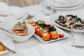 Appetizer. Cold table. dish of red fish on the table with salads and greens