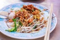 Appetizer dish of traditional Thai street food, Kuay Tiew Lui Suan, Fried Minced Pork and dried shrimp with Noodle Pad served with Royalty Free Stock Photo