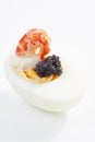Appetizer with egg, shrimp and caviar, close-up