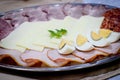 Appetizer with eggs, cheese and sliced sausage and meat Royalty Free Stock Photo