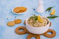 Appetizer, fish pate from mackerel, boiled eggs and onions in a white ceramic bowl on a blue concrete background. Served with Royalty Free Stock Photo