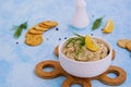 Appetizer, fish pate from mackerel, boiled eggs and onions in a white ceramic bowl on a blue concrete background Royalty Free Stock Photo