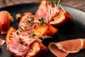 Appetizer Grilled peach with prosciutto, capers, microgreen, Food recipe background Royalty Free Stock Photo