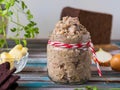 Appetizer, herring, onion and boiled egg forshmak in a glass jar on a wooden background. Jewish cuisine