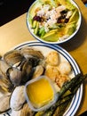 plate of steamers scallops, melted butter, asparagus, and a side salad avocado