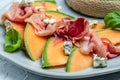 Appetizer, melon with jamon and Basil. Antipasti, Italian food. Restaurant menu, dieting, cookbook recipe top view